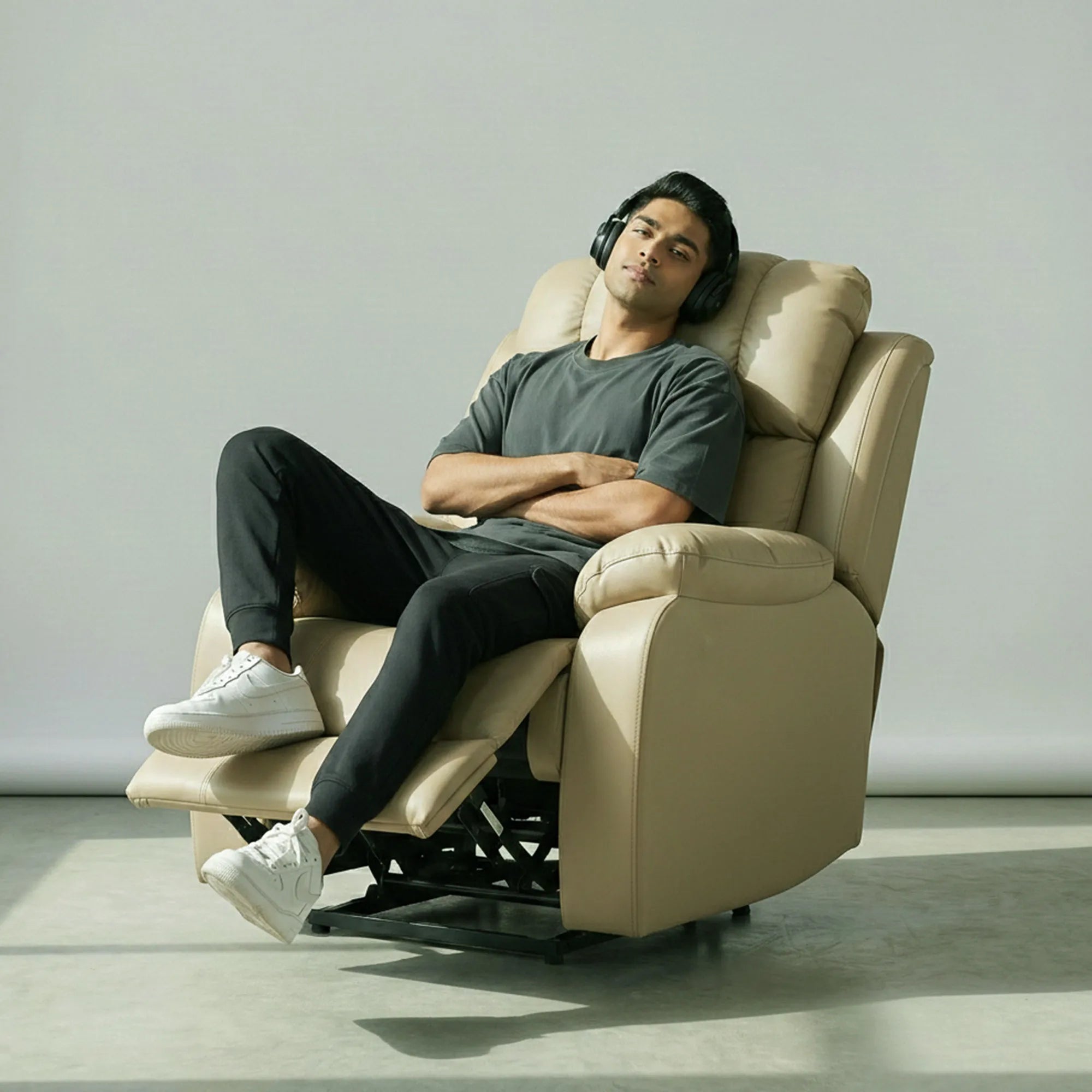 Man relaxing on Hush Hiven Big B beige motorized recliner leatherette single seater power recliner chair