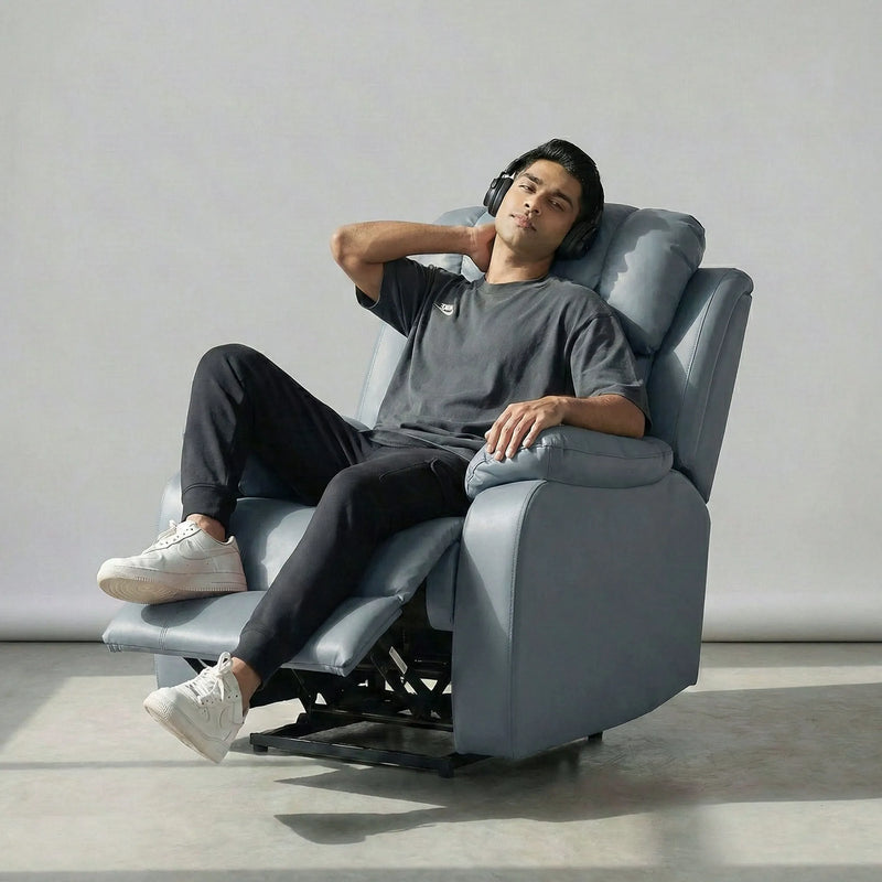 Man relaxing on Hush Hiven Big B grey motorized recliner leatherette single seater power recliner chair