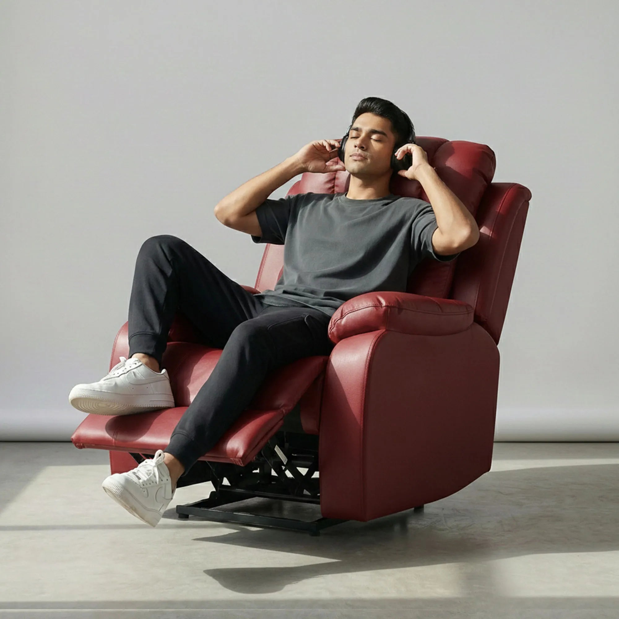 Man listening to music on Hush Hiven Big B motorized recliner maroon leatherette single seater power recliner