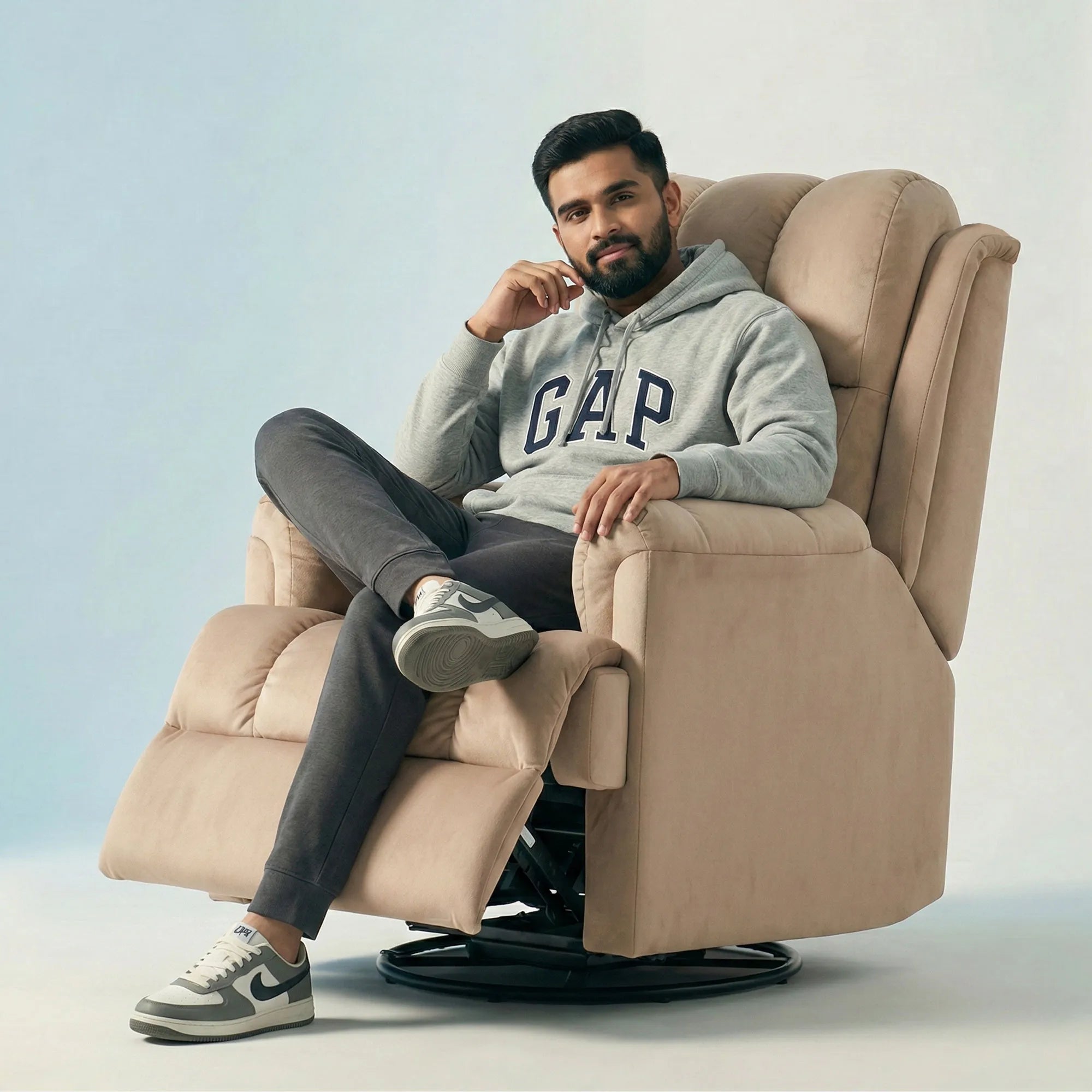 Man relaxing on Hush Hiven Donna beige smooth velvet motorized recliner chair dual motion luxury recliner