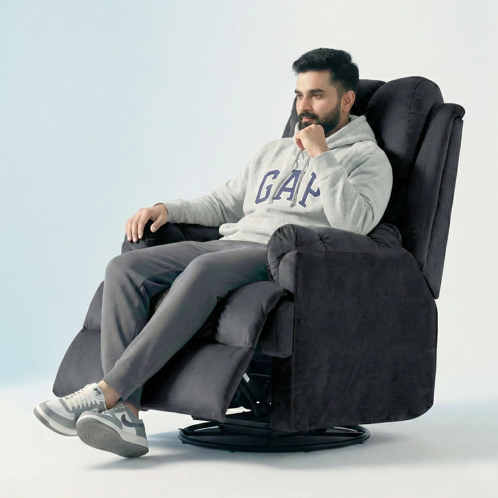 Man relaxing on Hush Hiven Donna black smooth velvet motorized recliner chair dual motion luxury recliner