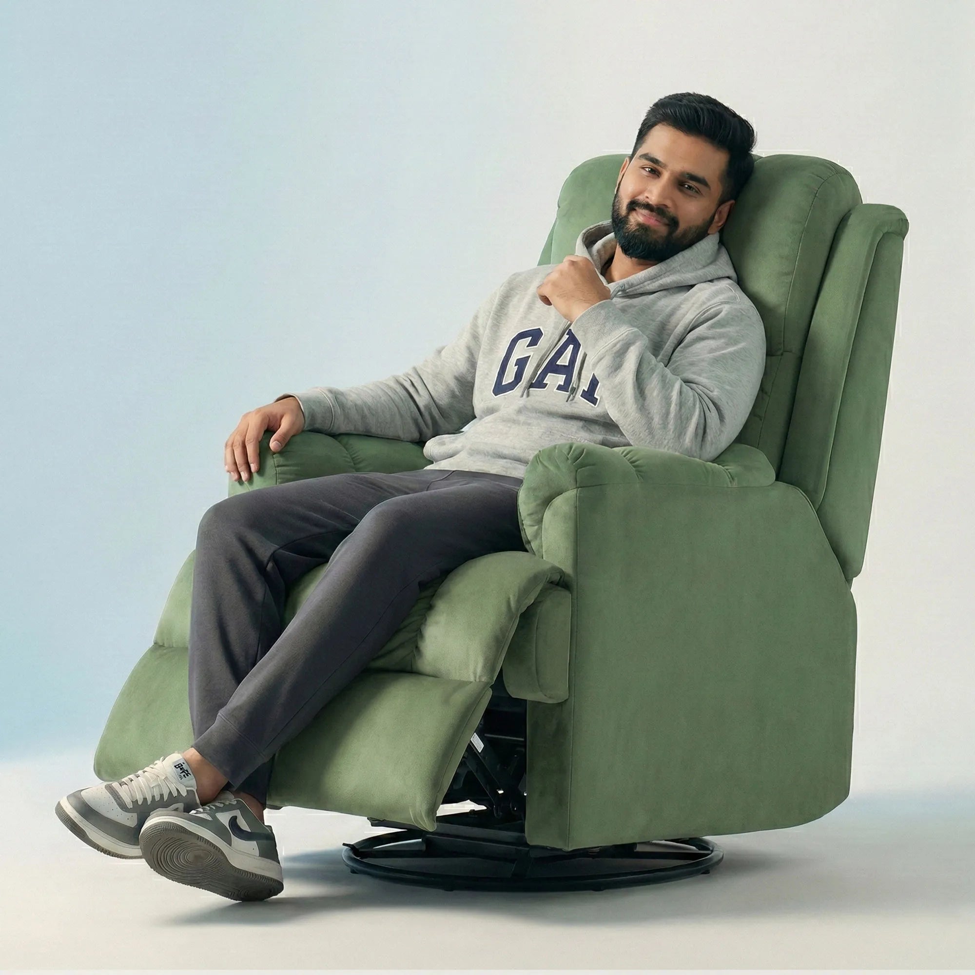 Man relaxing on Hush Hiven Donna light green smooth velvet motorized recliner chair dual motion luxury recliner