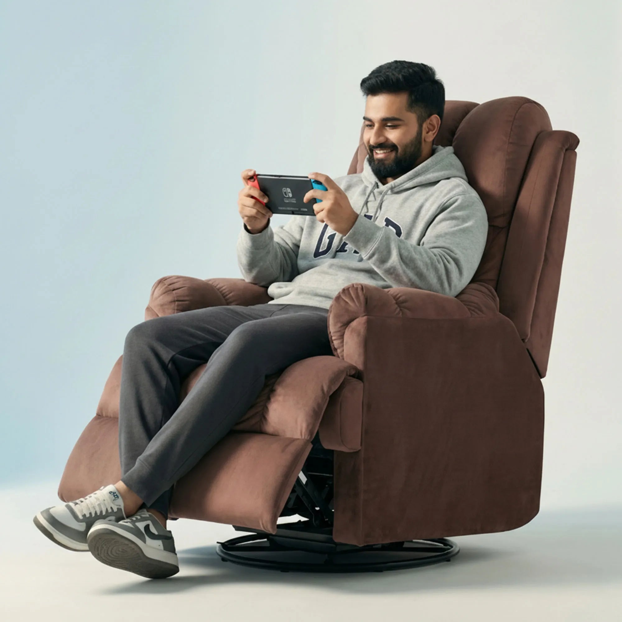 Man gaming on Hush Hiven Donna pink smooth velvet motorized recliner chair dual motion luxury recliner