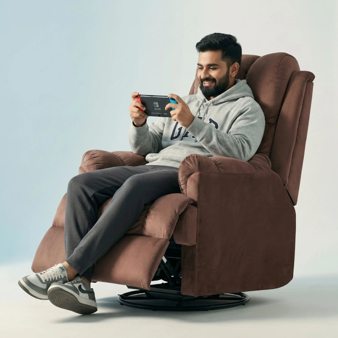 Man gaming on Hush Hiven Donna pink smooth velvet motorized recliner chair dual motion luxury recliner