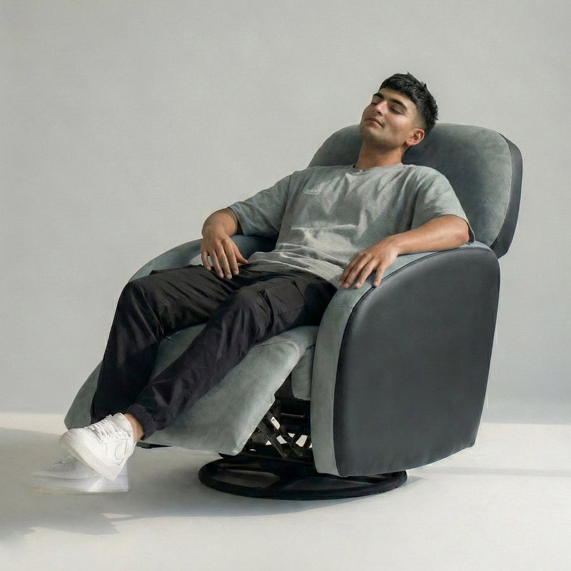 Man resting on Hush Hiven Pebble motorized recliner chair black dual tone boucle leatherette with footrest
