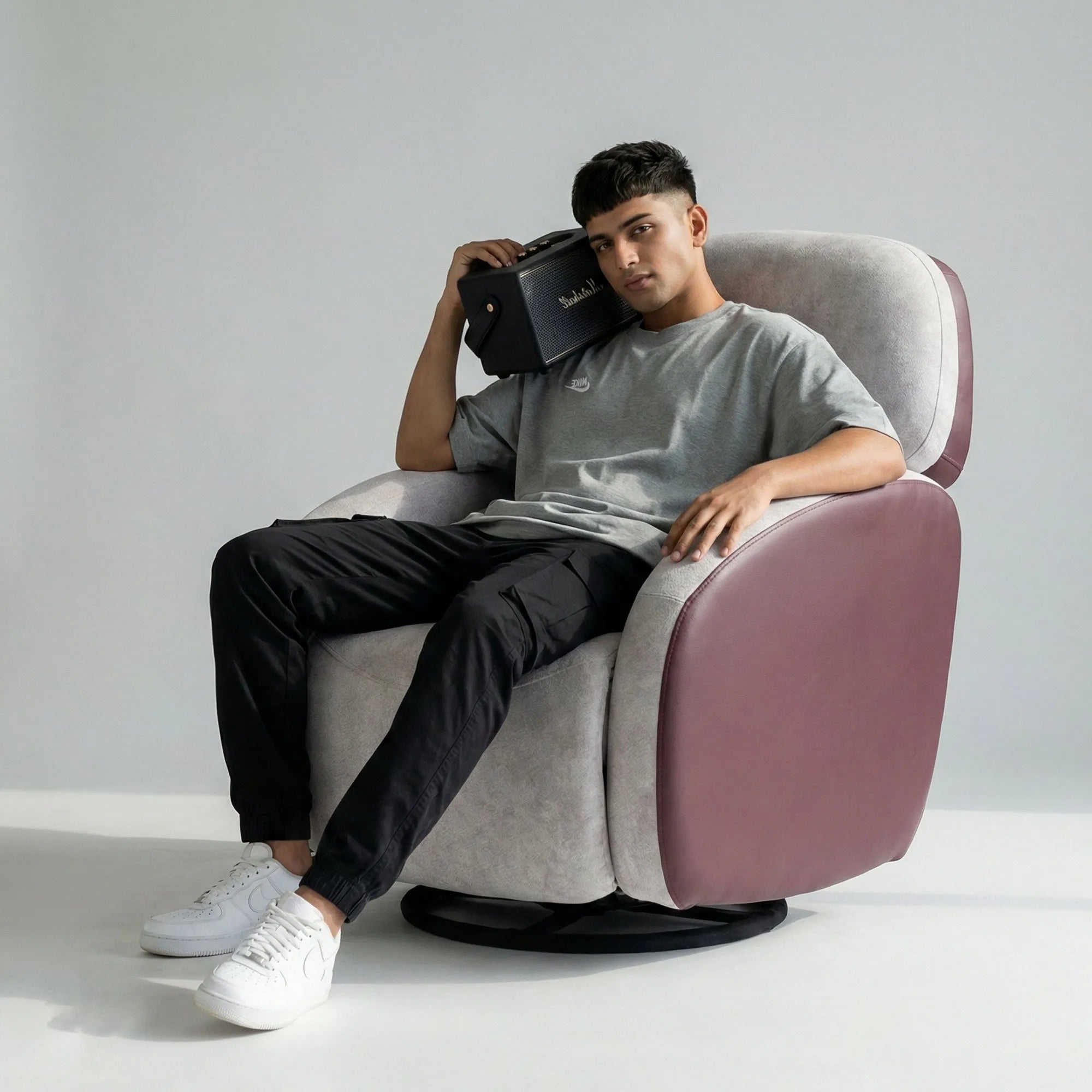 Man relaxing on Hush Hiven Pebble motorized recliner chair maroon dual tone boucle leatherette single seater